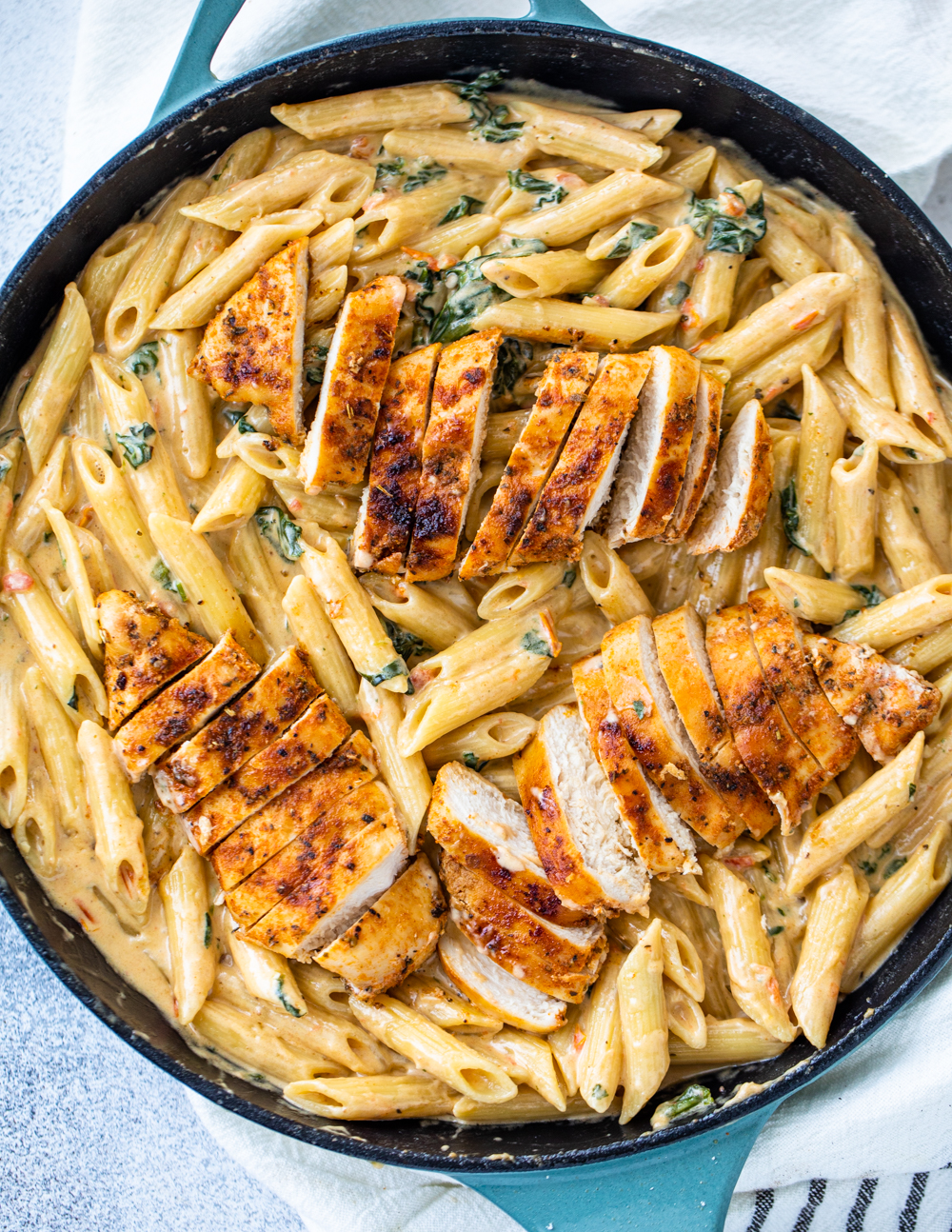 creamy garlic chicken pasta with tomatoes and spinach